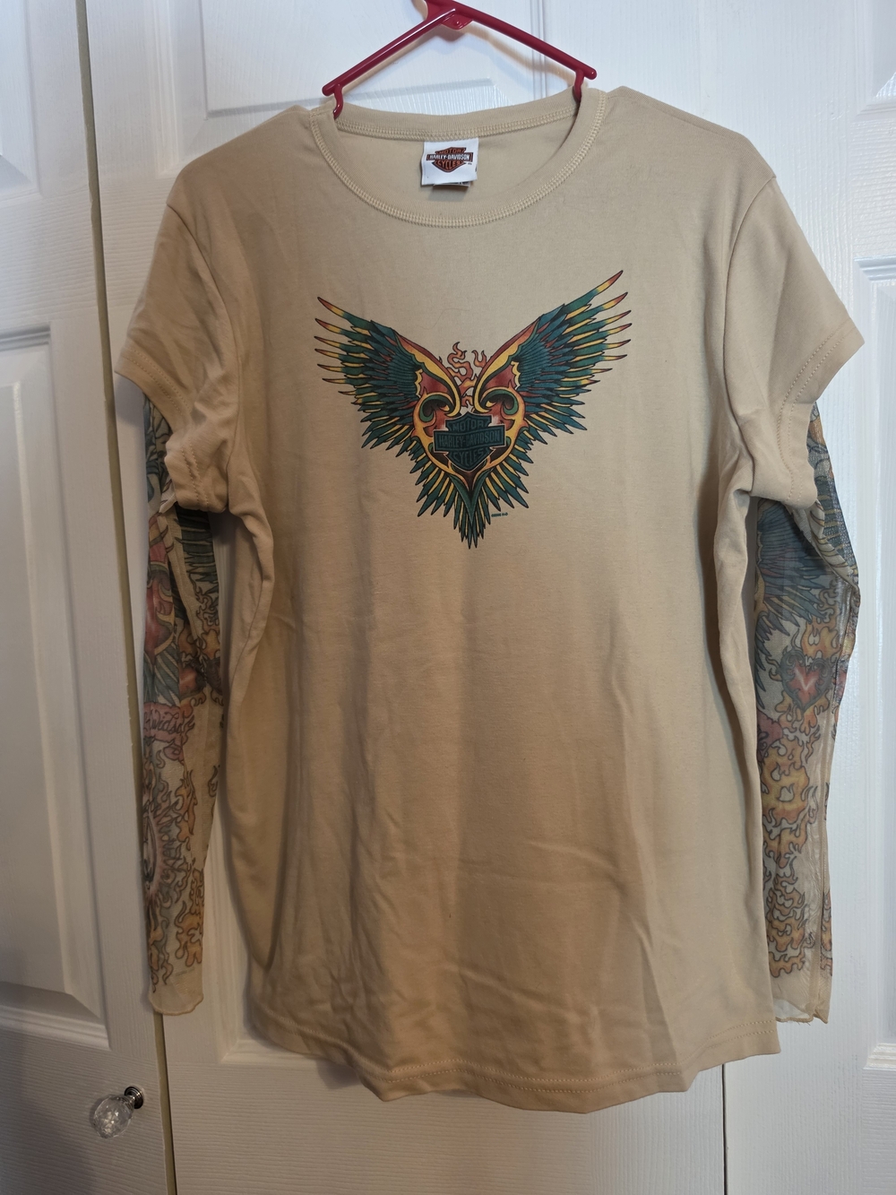 Vintage Y2K Harley-Davidson Winged Logo T-Shirt with Mesh Tattoo Sleeves.